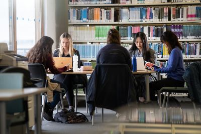 Student studying at study space with laptop in Business
