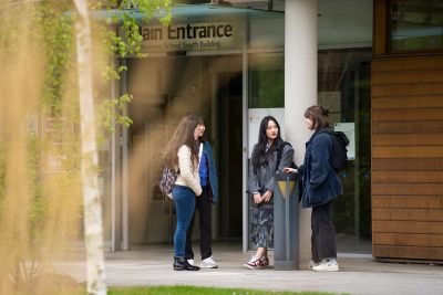 Students standing outside Business School South building on Jubilee campus.From left to right: Joanna Holland, Jiyoon Kim, Seungeun Kim, Emily Trappen.