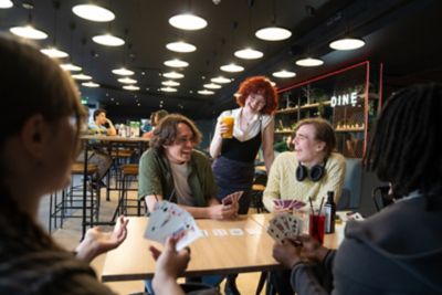 Undergraduate students playing cards in the Portland Building's Mooch bar on University Park campus