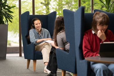 Students studying in drop-in chairs in Hallward Library.From left to right: Liberty Lee, Hannah Parker, Emily Trappen.