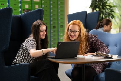 Students studying in drop-in chairs in Hallward Library.From left to right: Hannah Parker, Gloria Lowe, Liberty Lee (background).