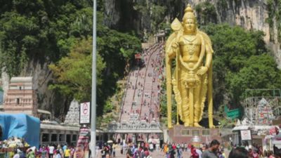 A wide upwards panning shot of the entrance to the Batu Caves in Kuala Lumpur