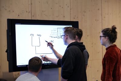 Undergraduate students using interactive whiteboards in the Monica Partridge building. February 2019.