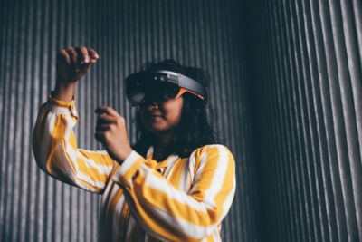 Undergraduate student using a VR headset in the Monica Partridge Digital Hub