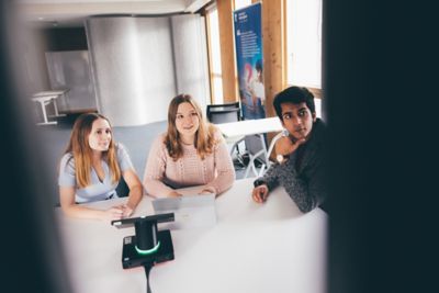 University undergraduate students using screens to hold a Teams call in the Monica Partridge Building Digital Hub. Friday November 5th 2021.Megan Mahoney (blue top); Khaqan Khan and Lucy Woodward (pink jumper)