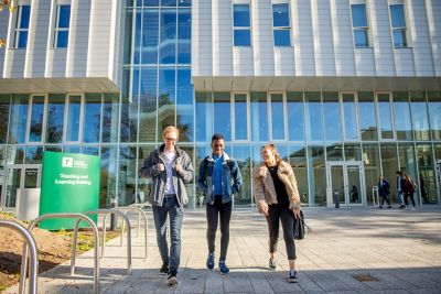 Undergraduate students walking in front of the Monica Partridge Building, University Park