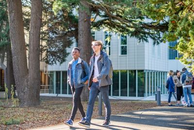 Undergraduate students walking in front of the Monica Partridge Building, University Park