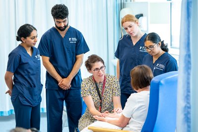 Medical students being taught how to do a hand examination in a small group teaching session