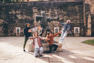 Undergraduate students visiting the Robin Hood statue at Nottingham Castle, Nottingham City Centre - November 2021.Mariam Abedraba Abdalla (pink hat);  Emily hay (orange hoodie); Luca Ion (cap) and Dominic Beale (red shirt).