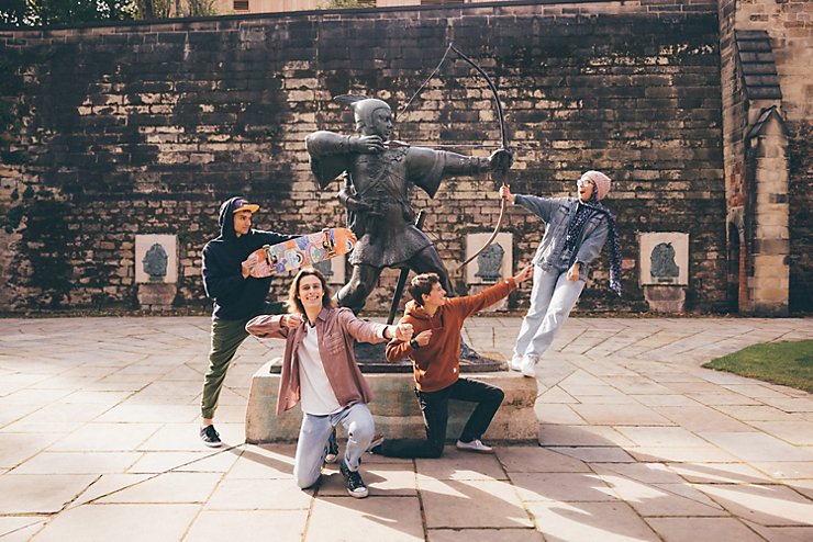 Undergraduate students visiting the Robin Hood statue at Nottingham Castle, Nottingham City Centre - November 2021.Mariam Abedraba Abdalla (pink hat);  Emily hay (orange hoodie); Luca Ion (cap) and Dominic Beale (red shirt).