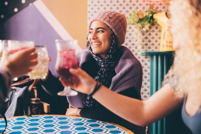 Undergraduate students relaxing in The Secret Garden restaurant in Nottingham City Centre - November 2021.Mariam Abedraba Abdalla (pink hat) and Fearne Darbyshire (curly blonde hair).