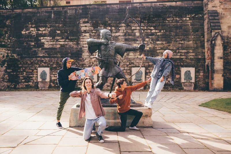 Undergraduate students visiting the Robin Hood statue at Nottingham Castle, Nottingham City Centre - November 2021.Mariam Abedraba Abdalla (pink hat);  Emily hay (orange hoodie); Luca Ion (cap) and Dominic Beale (red shirt).