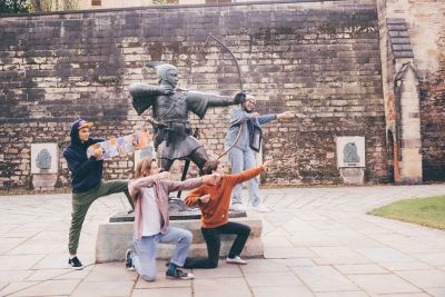 Undergraduate students visiting the Robin Hood statue at Nottingham Castle, Nottingham City Centre - November 2021.Mariam Abedraba Abdalla (pink hat); Emily hay (orange hoodie); Luca Ion (cap) and Dominic Beale (red shirt).