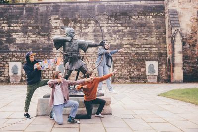 Undergraduate students visiting the Robin Hood statue at Nottingham Castle, Nottingham City Centre - November 2021.Mariam Abedraba Abdalla (pink hat); Emily hay (orange hoodie); Luca Ion (cap) and Dominic Beale (red shirt).