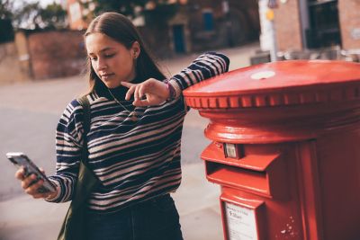 Undergraduate students leaning on a postbox in Nottingham City Centre - November 2021