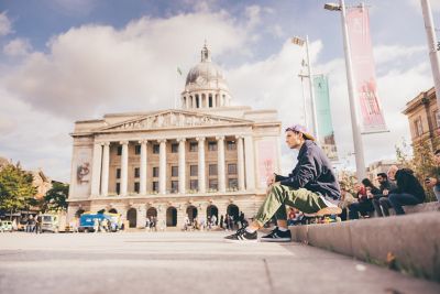 Undergraduate students skate boarding in front of the Nottingham Council House in Nottingham City Centre