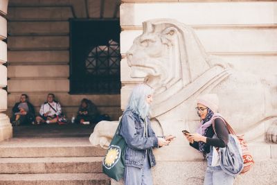 Undergraduate students standing in front of the Nottingham Council House lions in Nottingham City Centre