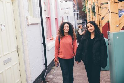 Undergraduate students socialising in Cobden Chambers,  Nottingham City Centre - November 2021.Sophie Kucharska Gibson (pink jumper) and Sarah Andraous (black jacket).