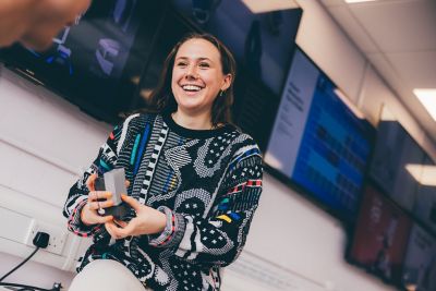 An undergraduate student shows her design to a fellow student