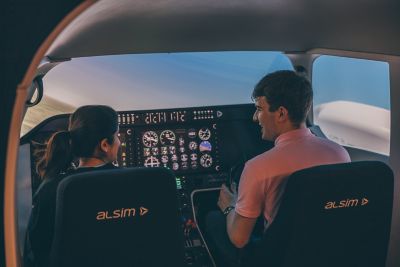 Undergraduate students piloting and co-piloting the flight simulator in engineering labs