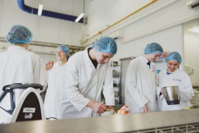 Undergraduate students working with food in the Food Processing Hall, Brewing and Bioenergy Building, Sutton Bonington