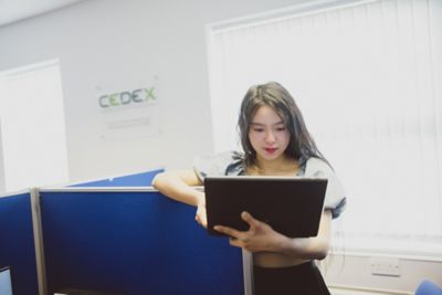 Undergraduate student looking at laptop in CeDEx lab, Clive Granger building