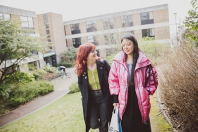 Pair of undergraduate students walking outside the Clive Granger building, University park campus