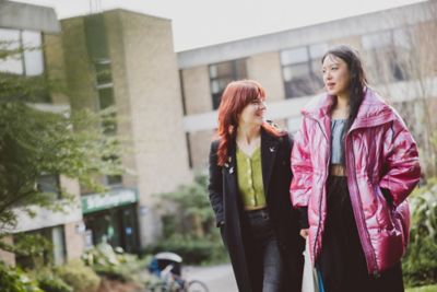 Pair of undergraduate students walking outside the Clive Granger building, University park campus