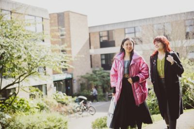 Pair of undergraduate students walking outside the Clive Granger building, University park campus