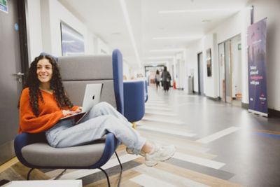 Undergraduate student working on laptop in Lower Ground Floor of Portland Building