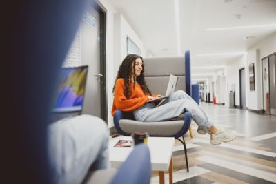 Undergraduate student working on laptop in Lower Ground Floor of Portland Building