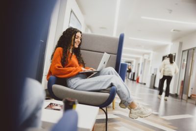 Undergraduate student working on laptop in Lower Ground Floor of Portland Building