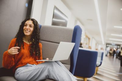 Undergraduate student working on laptop in Lower Ground Floor of Portland Building