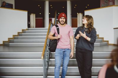 Undergraduate students walking down stairs outside Saijokai Pan Asia, Portland Building