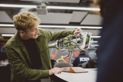 A foundation student looking at the Rolls Royce rocket engine in the Advanced Manufacturing Building C9