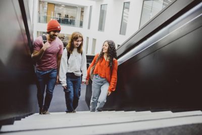 Students Zaffar Ullah, Amy Berry and Anoria Demetriou walking up the stairs in the Advanced Manufacturing Building