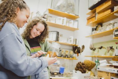 Pair of postgraduate students looking at fluid-preserved specimen in Life Sciences building, University Park campus