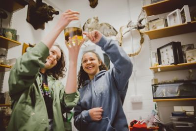 Pair of postgraduate students looking at fluid-preserved specimen in Life Sciences building, University Park campus
