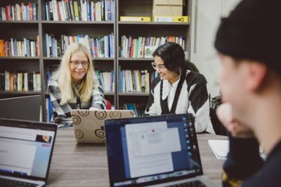 Undergraduate students in a tutorial with an academic