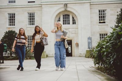 Undergraduate students walking in the Trent Building quadrangle