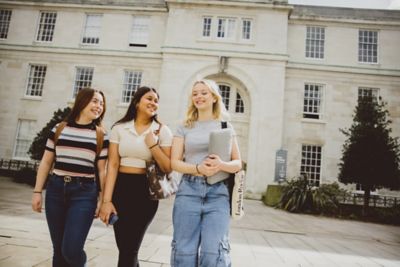 Undergraduate students walking in the Trent Building quadrangle