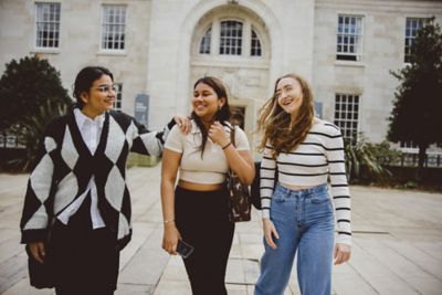 Undergraduate students walking in the Trent Building quadrangle