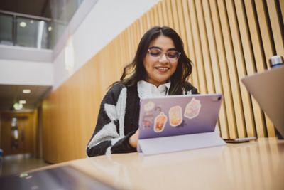 Student studying in the Humanities building atrium
