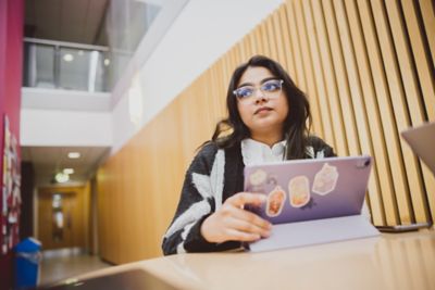 Student studying in the Humanities building atrium