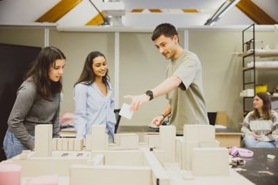 Undergraduate architecture students Martina Avila, Khushi Patel and Ajay Lancaster Khosla working in the design studio in the Environmental Education Centre