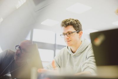 An undergraduate student working on a laptop in the PDM Design Studio