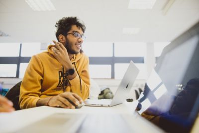 An undergraduate studying on their laptop in the PDM Design Studio