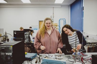 Students work at creating an artificial solar storm in the A14 Physics Labs in the Physics Building