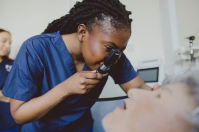 Student using an ophthalmoscope on a manikin, Clinical Skills room D1035, Queen's Medical Centre Medical School, University Park