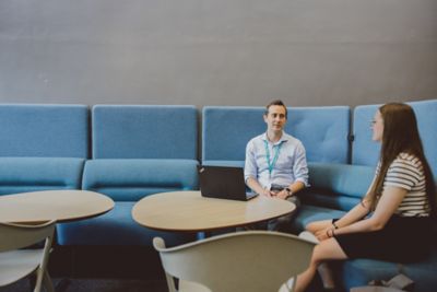 Staff member and Undergraduate student having 1:1 discussion in the reception area of the Medical School, QMC, University Park